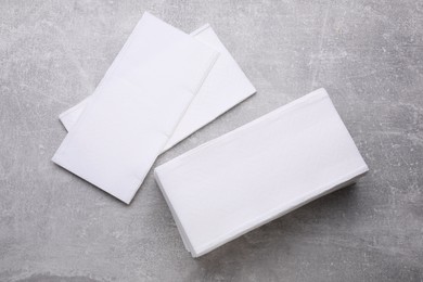 Clean tissue towels on light grey background, flat lay