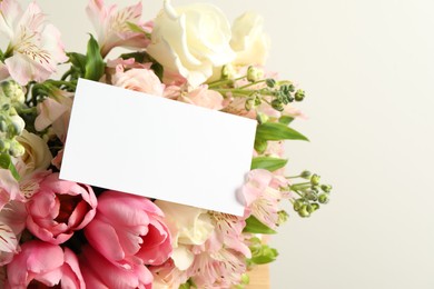 Photo of Happy Mother's Day. Beautiful flowers with blank card on light background, closeup