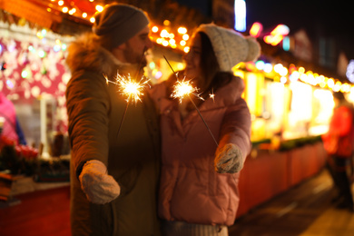 Photo of Happy couple spending time at Christmas fair