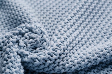 Photo of Beautiful light blue knitted fabric as background, closeup
