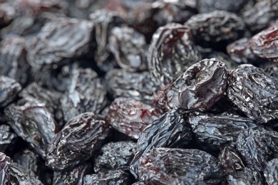 Tasty raisins as background, closeup. Healthy dried fruit