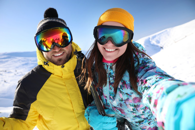 Photo of Couple taking selfie on hill. Winter vacation