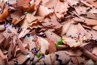 Photo of Pile of colorful pencil shavings as background, closeup