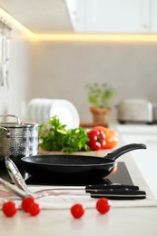 Photo of Countertop with different cooking utensils and vegetables in kitchen