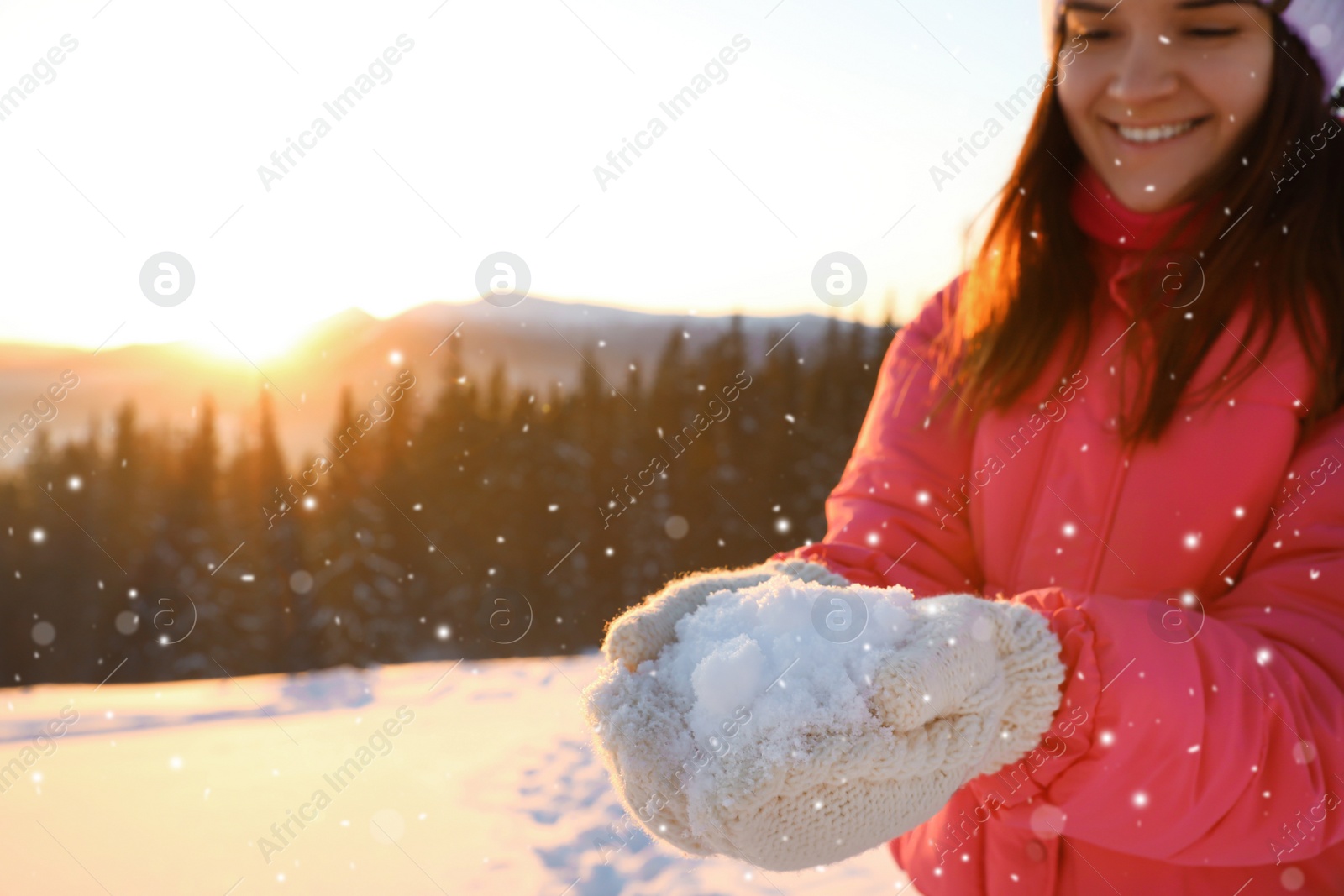 Photo of Woman holding pile of snow outdoors. Winter vacation