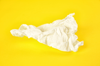 Photo of Used paper tissue on yellow background, closeup