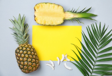 Photo of Fresh pineapples and coconut pieces on color background