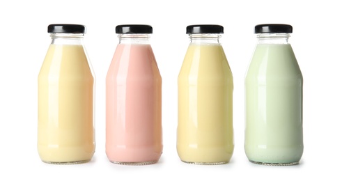 Photo of Bottles with different smoothies on white background