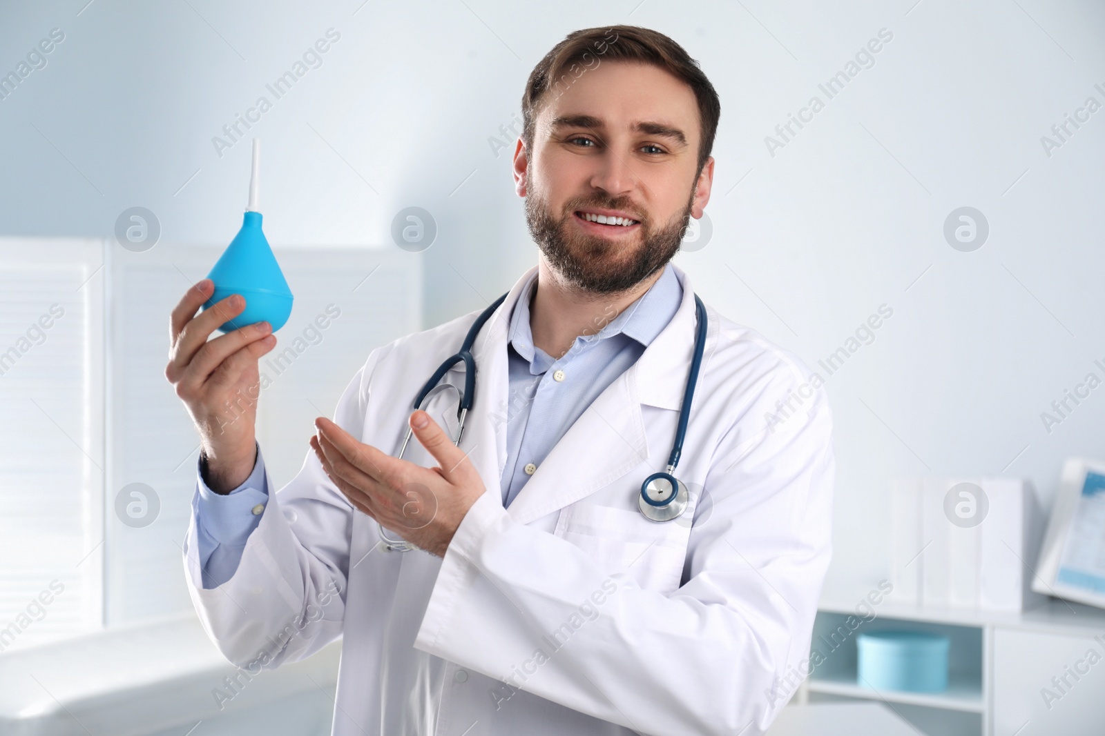 Photo of Doctor holding rubber enema in examination room