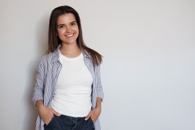Photo of Portrait of beautiful young woman on white background, space for text