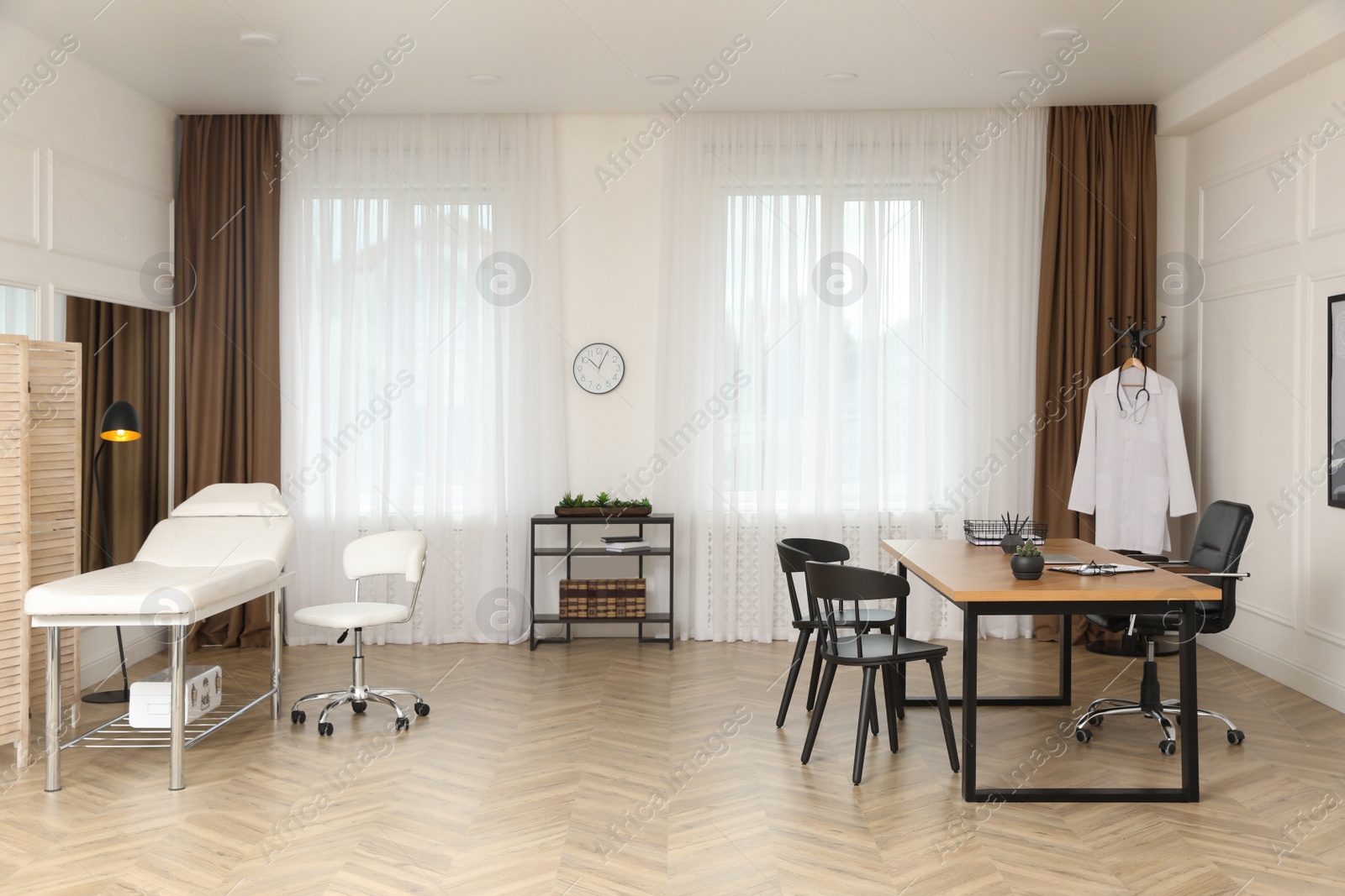 Photo of Modern medical office interior with doctor's workplace and examination table