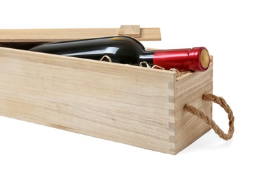 Photo of Open wooden crate with bottle of wine isolated on white