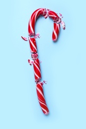 Photo of Crushed Christmas candy cane on light blue background, top view