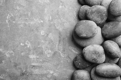 Photo of Zen stones on grey background, top view with space for text