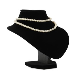 Photo of Stylish pearl necklace on jewelry bust against white background