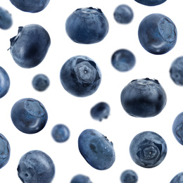 Image of Many fresh ripe blueberries falling on white background