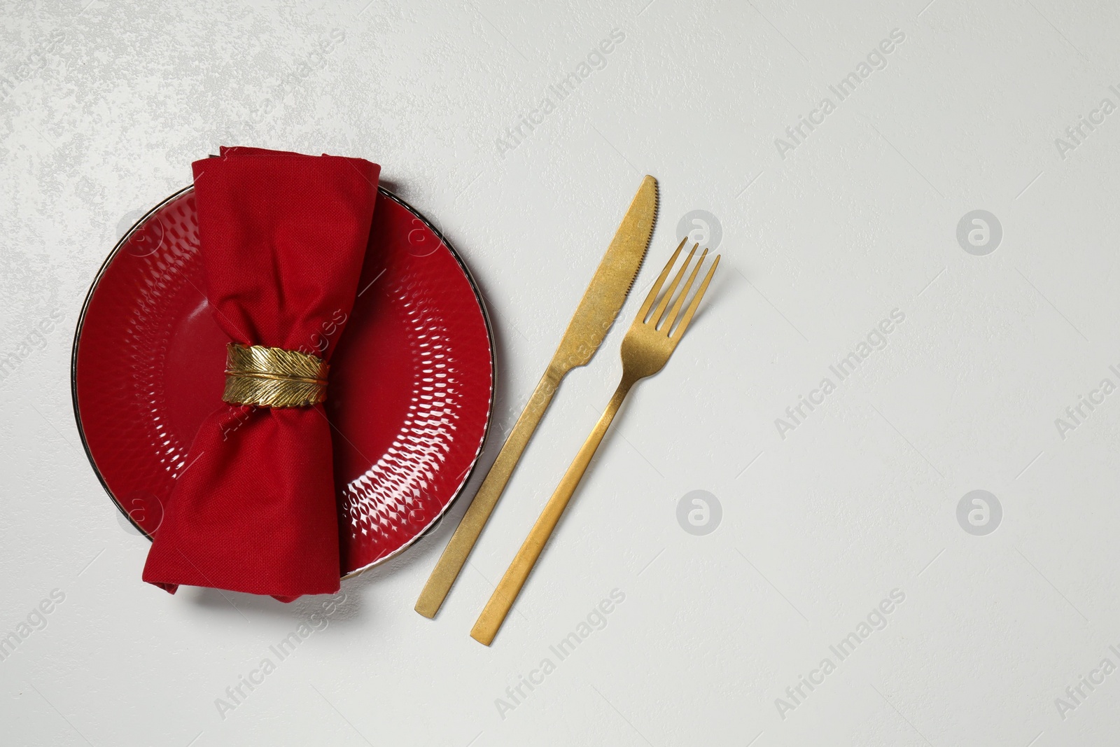 Photo of Stylish setting with elegant cutlery on white table, top view. Space for text