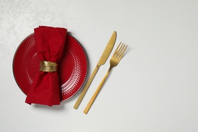Photo of Stylish setting with elegant cutlery on white table, top view. Space for text