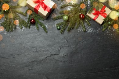 Photo of Flat lay composition with fir branches and Christmas decor on black background, space for text. Greeting card design