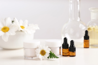 Photo of Skin care products, ingredients and laboratory glassware on table. Dermatology research