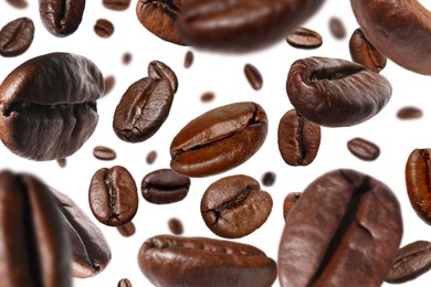 Image of Roasted coffee beans falling o white background