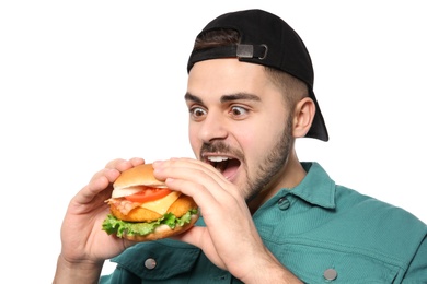 Handsome man eating tasty burger isolated on white