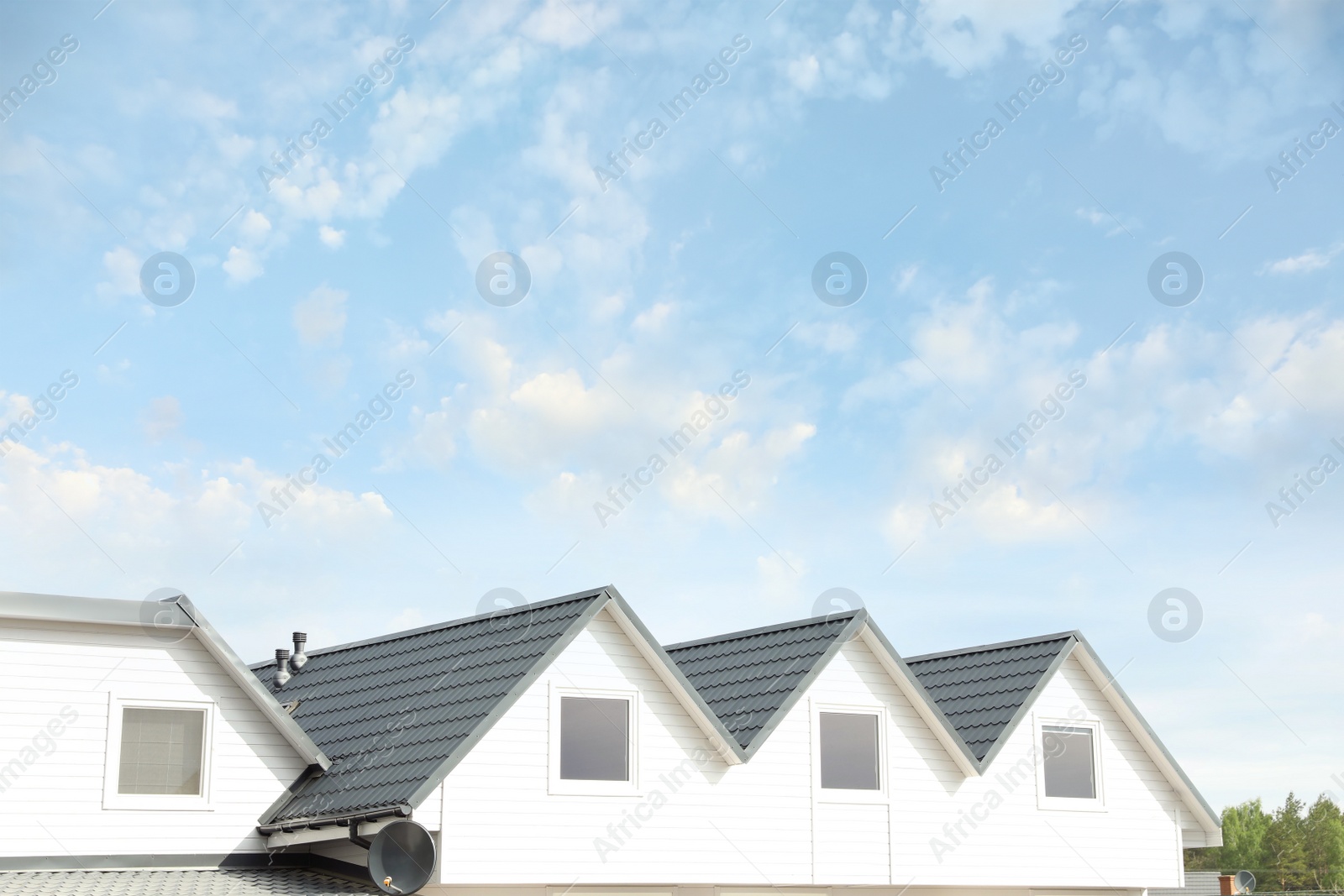 Photo of Modern building with grey roof outdoors on spring day