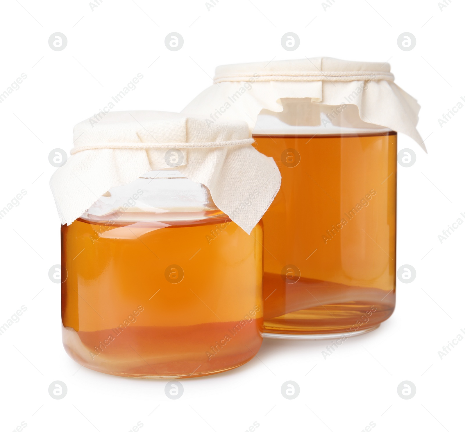 Photo of Tasty kombucha in glass jars isolated on white