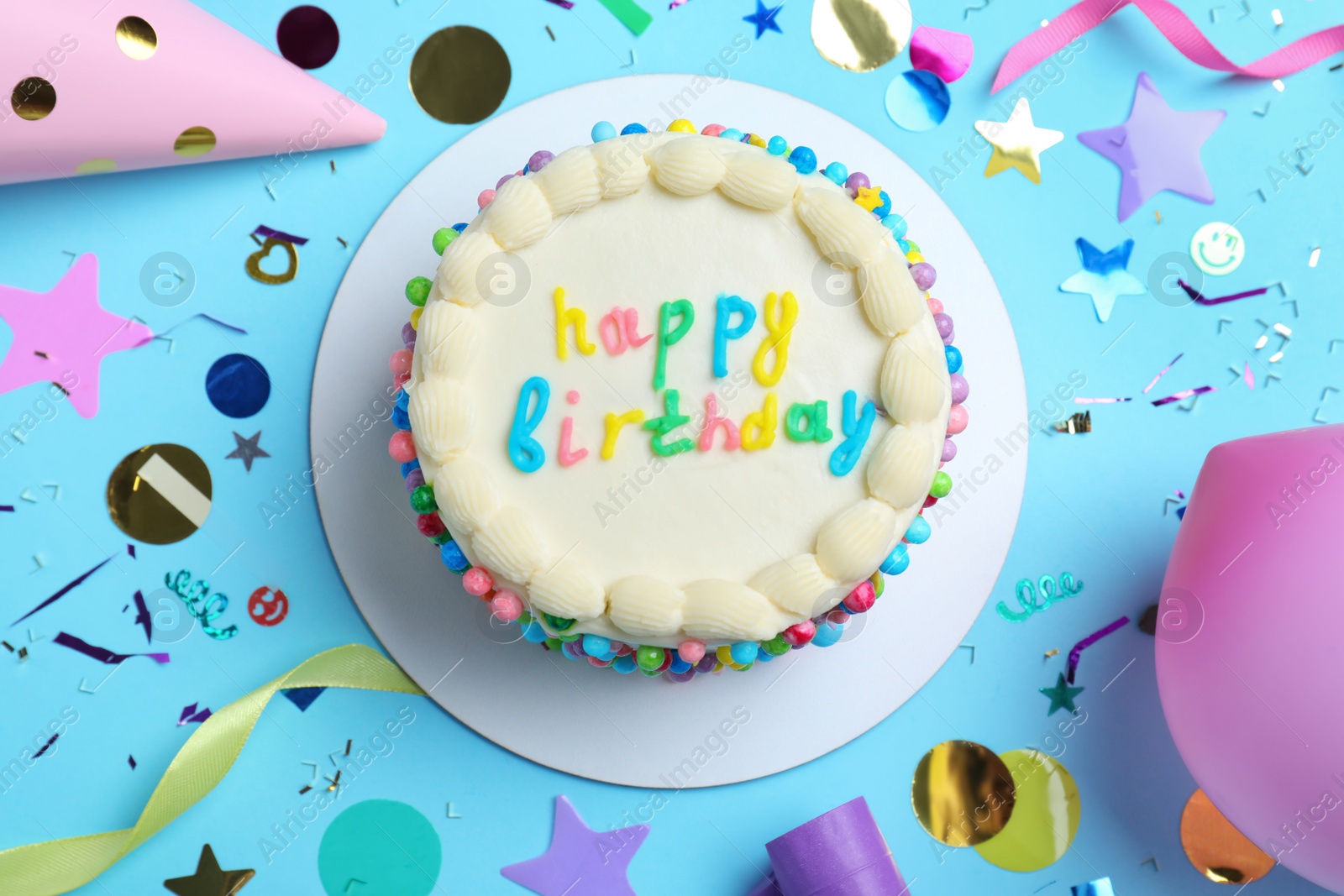 Photo of Cute bento cake with tasty cream and decor on light blue background, flat lay