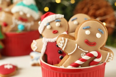 Delicious homemade Christmas cookies in bowl against blurred festive lights, closeup