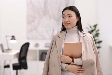 Photo of Portrait of beautiful businesswoman with tablet in office. Space for text