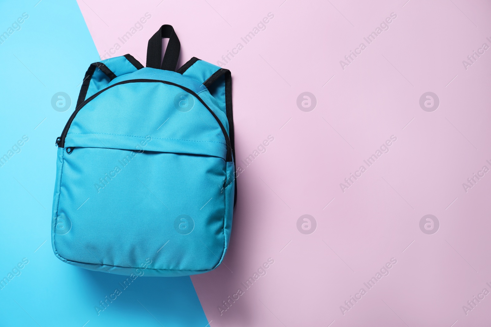 Photo of Stylish light blue backpack on color background, top view. Space for text