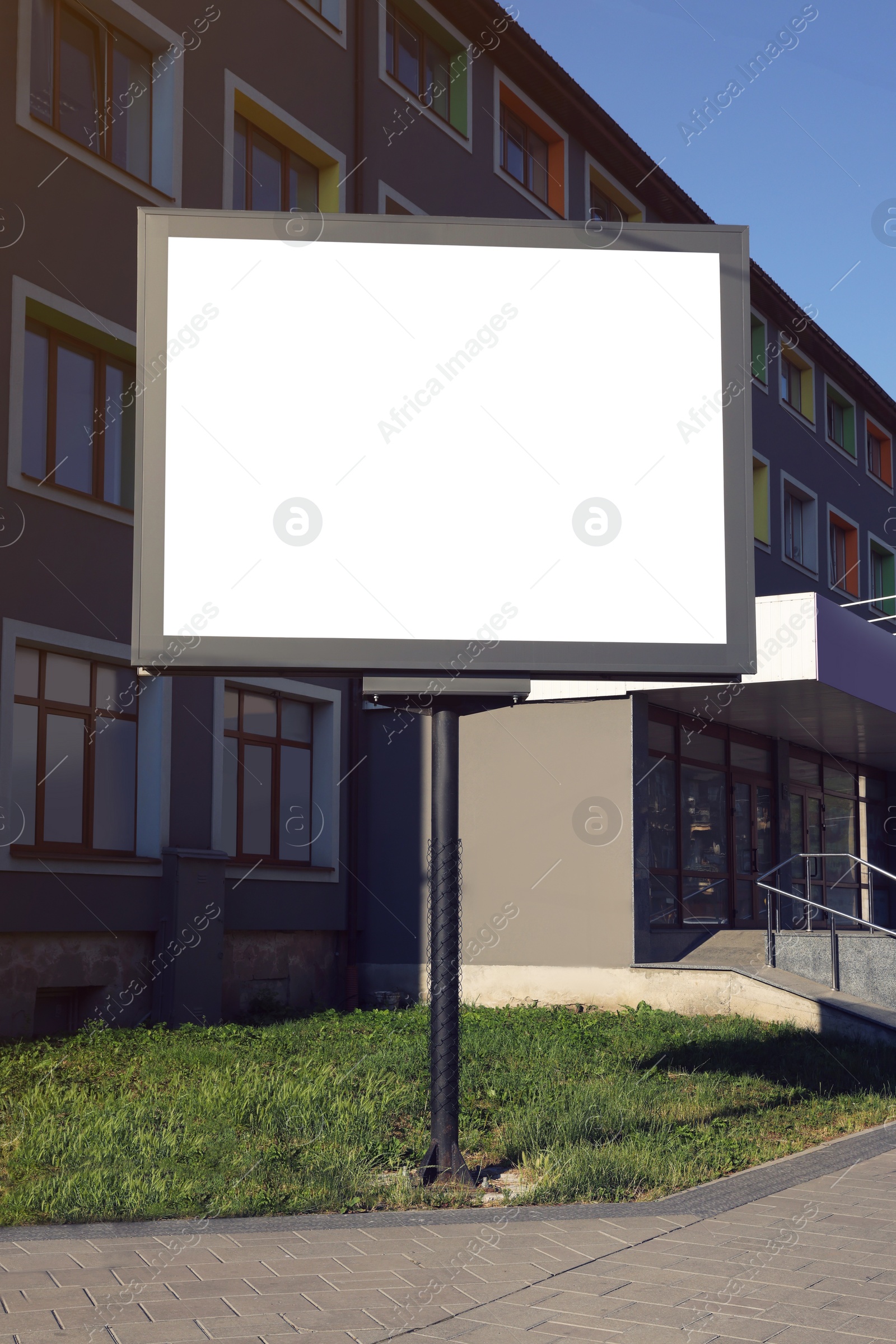 Photo of Blank advertising board on city street. Mockup for design