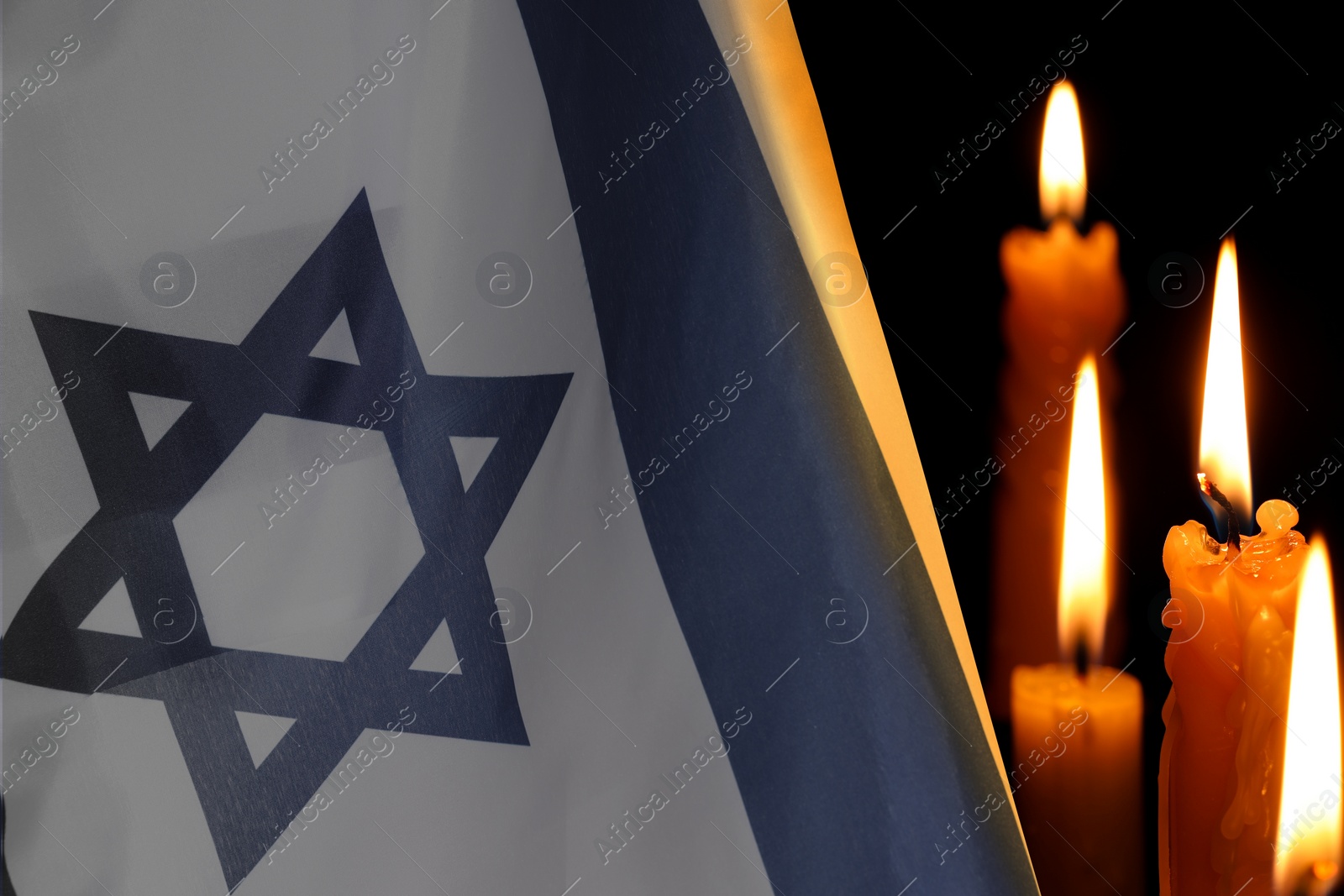 Image of Holocaust memory Day. Flag of Israel and burning candles