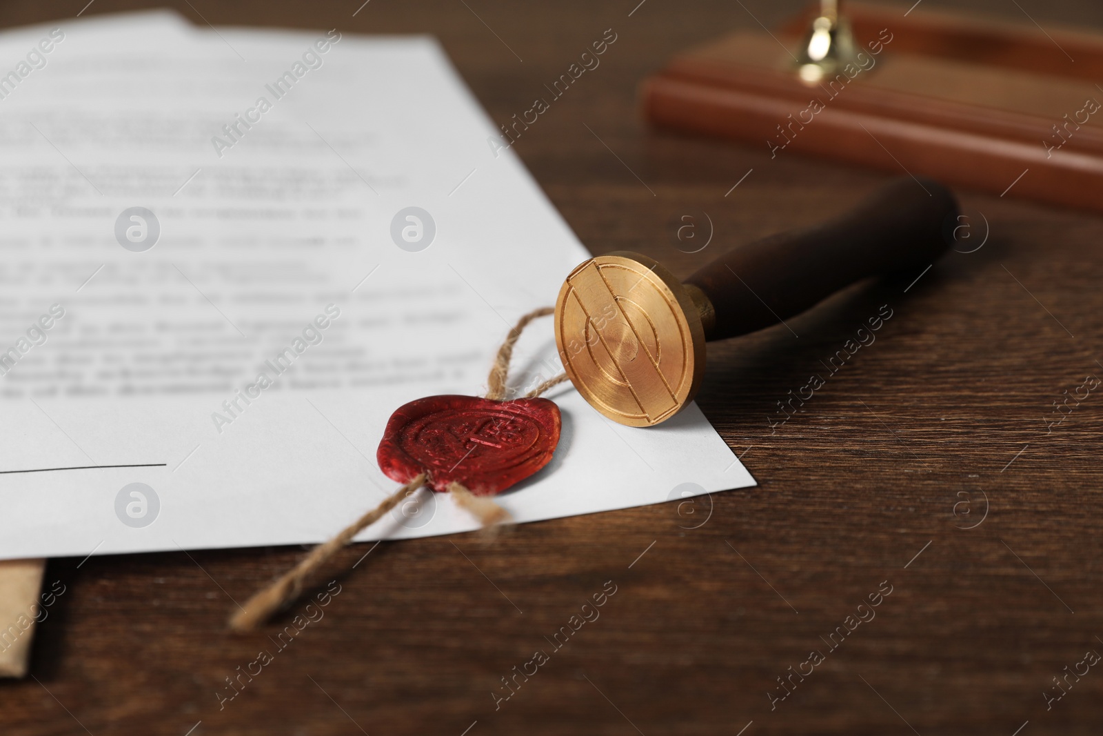 Photo of Documents and stamp on wooden table, closeup. Notary contract