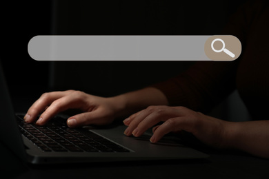 Image of Search bar of internet browser and woman working with laptop in darkness, closeup