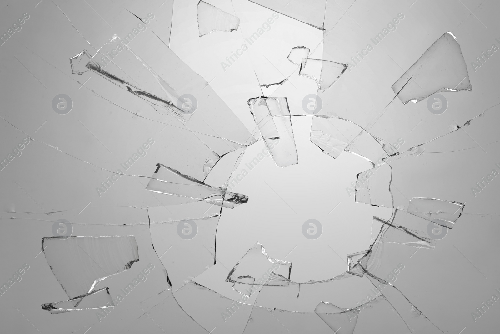 Image of Broken glass with cracks on light background