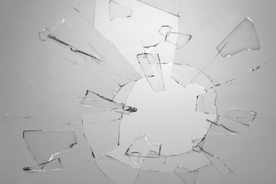 Image of Broken glass with cracks on light background