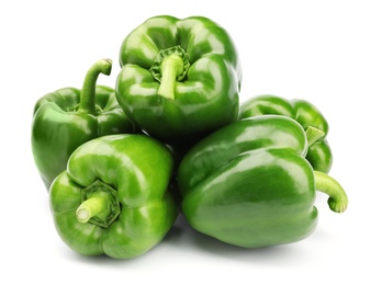 Pile of tasty green bell peppers on white background