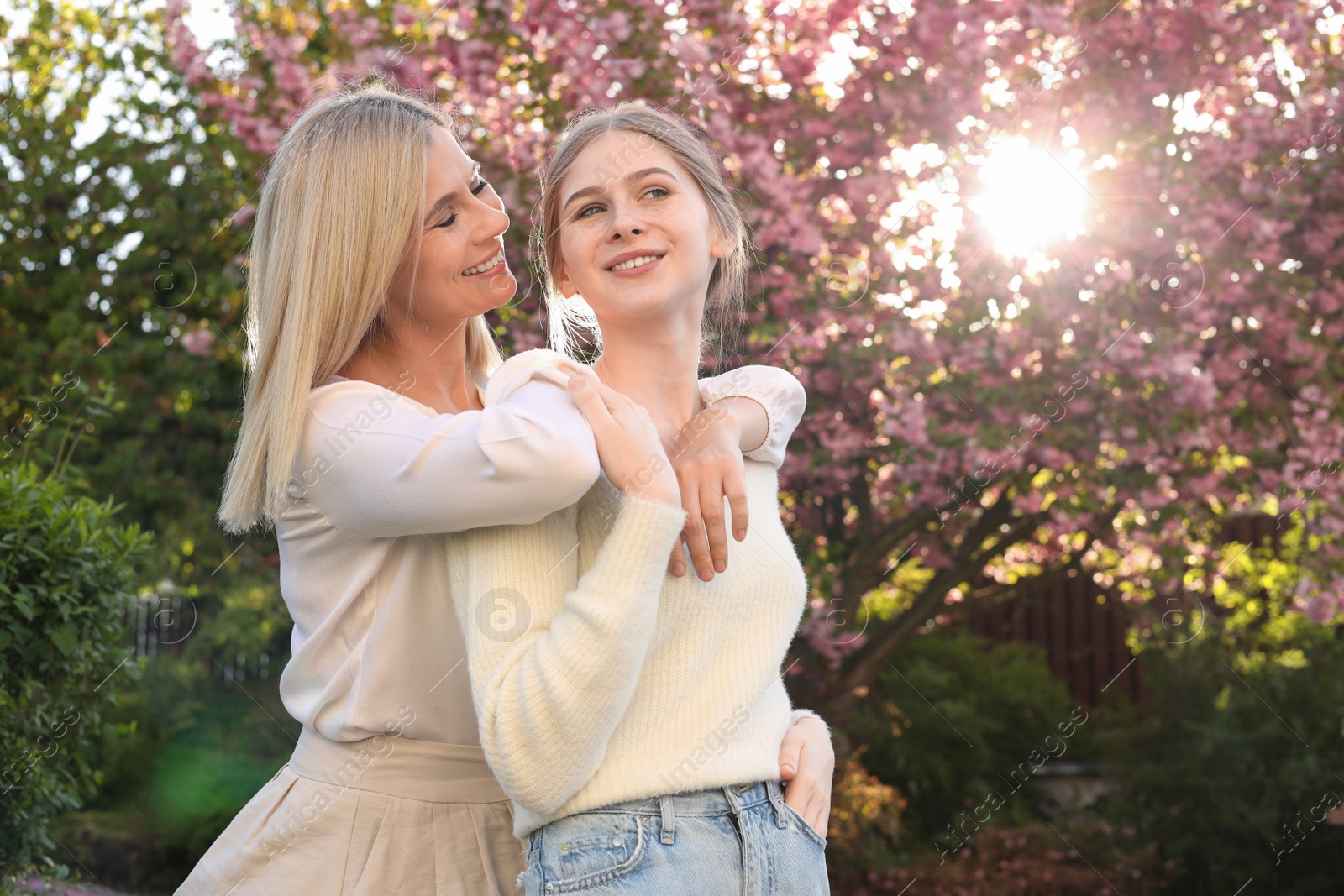 Photo of Happy mother with her daughter spending time together in park on sunny day