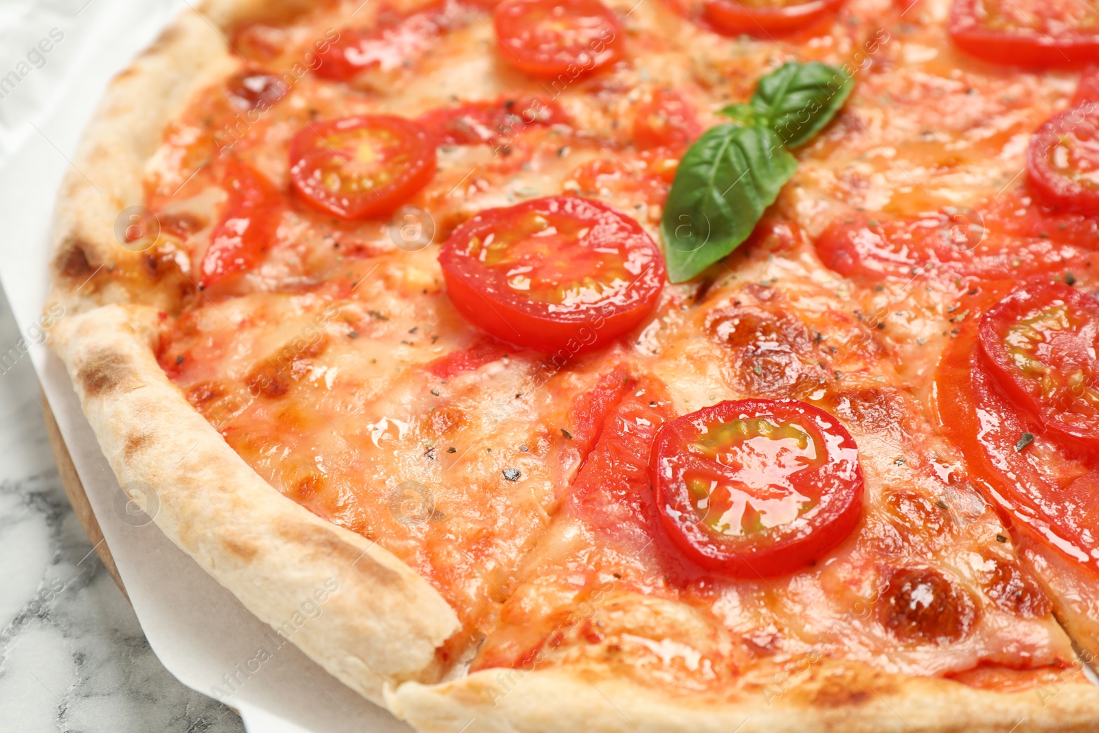 Photo of Delicious pizza Margherita on white marble table, closeup