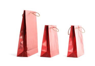 Photo of Red paper shopping bags isolated on white. Space for design