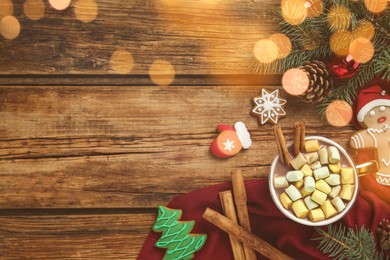 Photo of Delicious hot chocolate with marshmallows near cookies and Christmas decor on wooden table, flat lay. Space for text