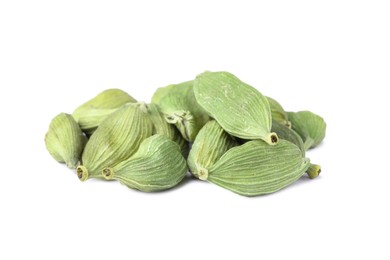 Pile of dry green cardamom on white background