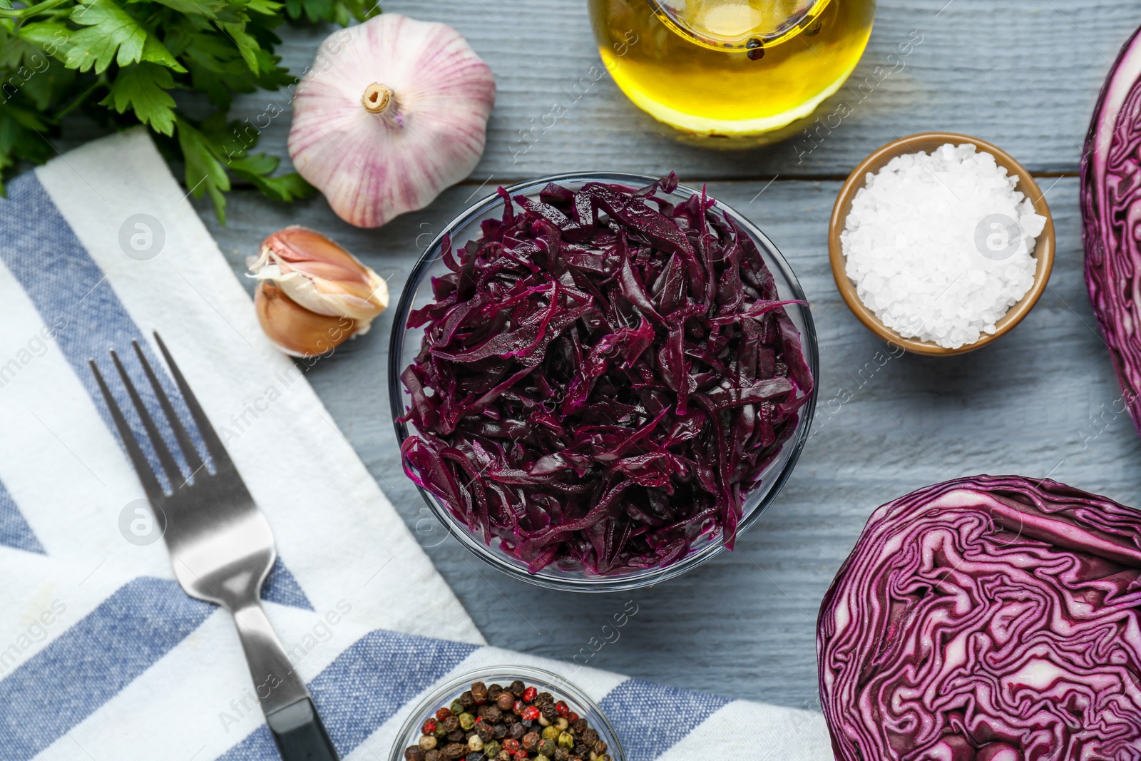 Photo of Tasty red cabbage sauerkraut and different ingredients on light grey table, flat lay