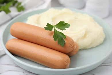 Photo of Delicious boiled sausages, mashed potato and parsley on table, closeup