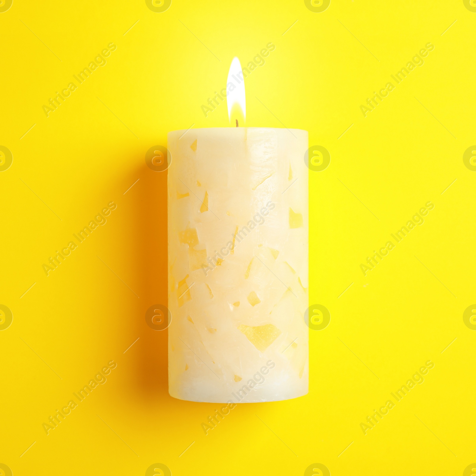 Photo of Alight scented wax candle on color background