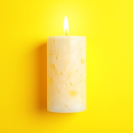 Photo of Alight scented wax candle on color background