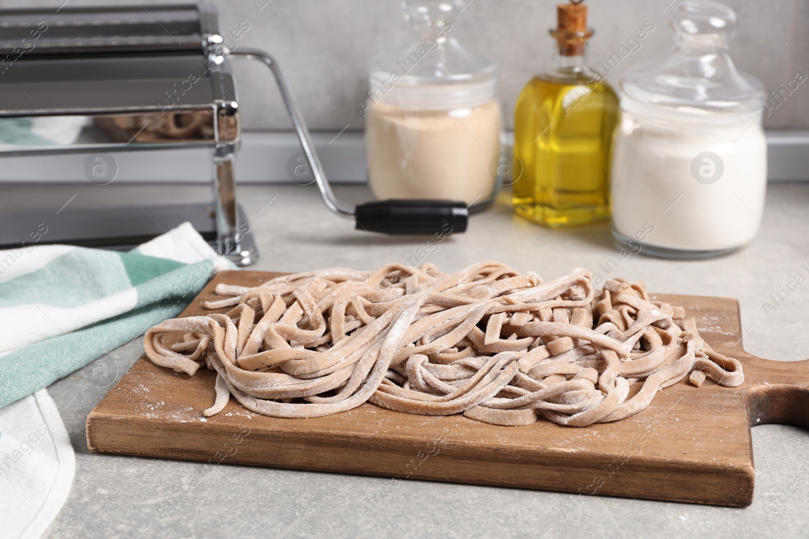 Photo of Uncooked homemade soba with wooden board on table