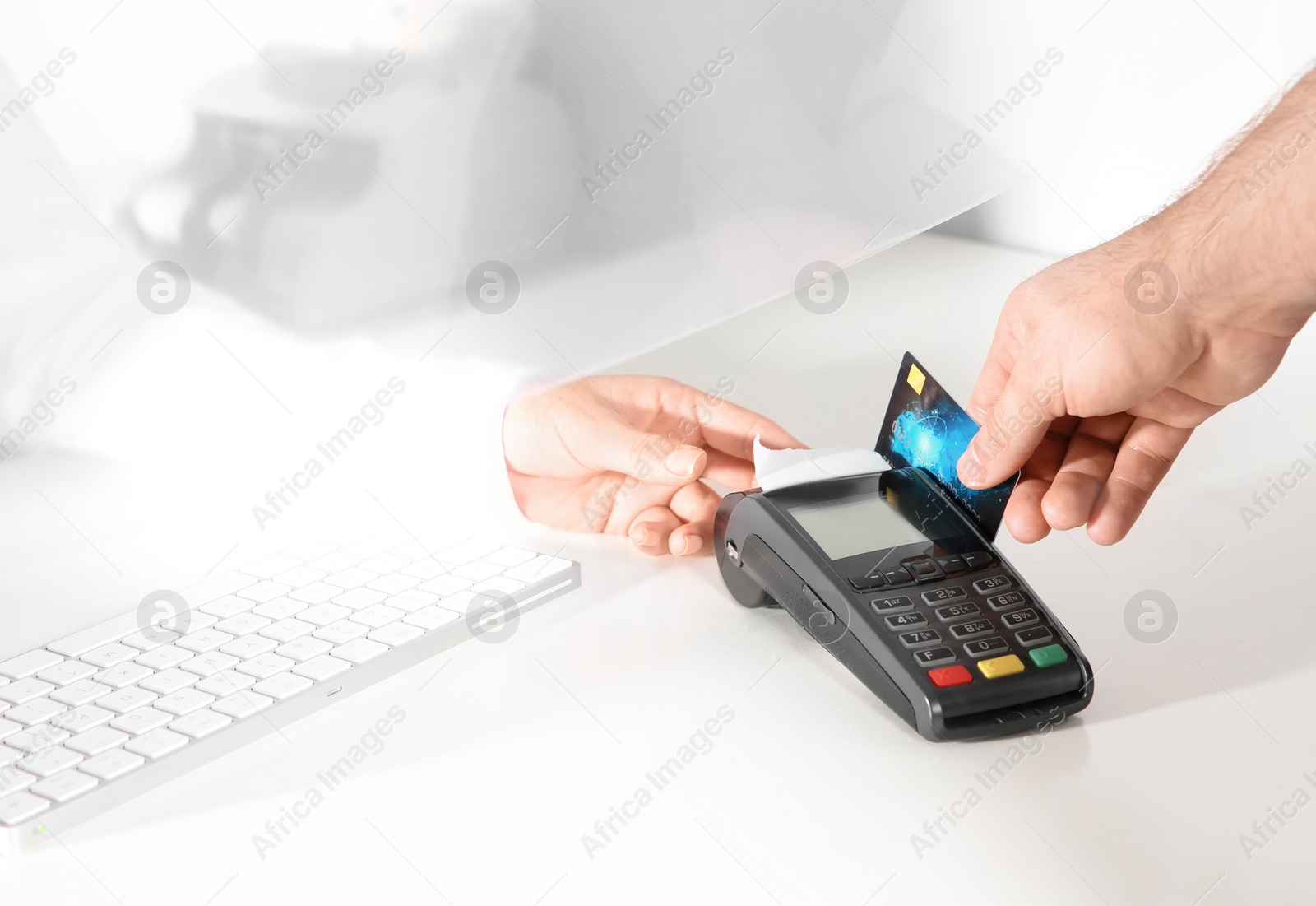 Photo of Man using bank terminal for credit card payment at cash department window, closeup